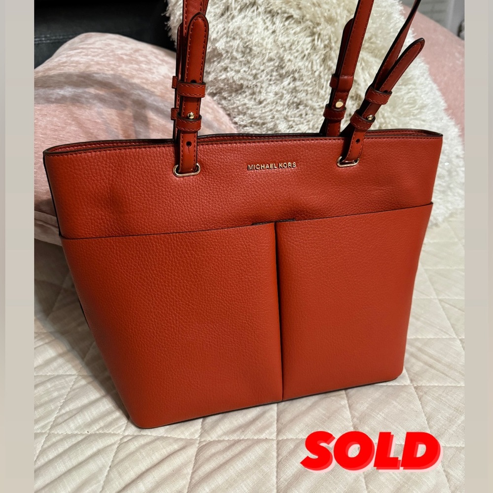 Brand New, authentic Michael Kors leather red/ginger color, genuine leather.